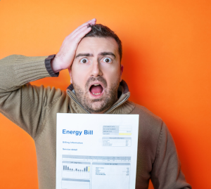 Man looking at Energy bill with surprise