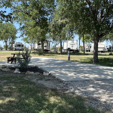 view of RV sites on paved platforms with a picnic table at Hidden Valley RV Park