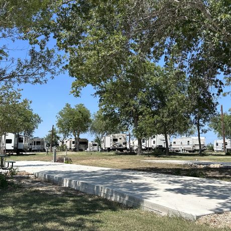 View of full hook-up sites with paved docks and RVs at Hidden Valley RV Park
