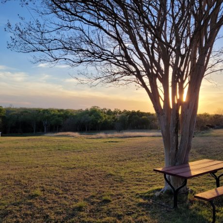 Beautiful view of a park picnic table and a sunset at Hidden Valley RV Park