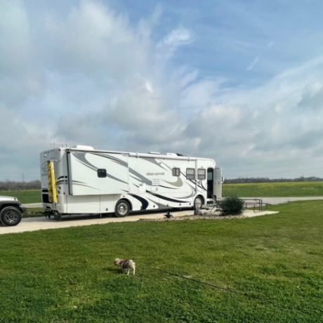 Motorhome on large concrete pad at a pull thru RV site.